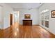 Spacious living room featuring gleaming hardwood floors, neutral walls, and a large picture window at 1544 Blue Bird Way, Cumming, GA 30041