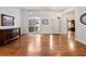 Open-concept living area with hardwood floors, bright windows, and view of entry door at 1544 Blue Bird Way, Cumming, GA 30041
