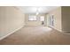 Spacious living room with plush carpeting, natural light, and access to other rooms at 1544 Blue Bird Way, Cumming, GA 30041