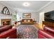 Cozy living room with a stone fireplace, comfortable seating, and a decorative rug at 1544 Blue Bird Way, Cumming, GA 30041