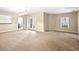 Large living room featuring neutral carpeting, ample natural light, and access to a dining area at 1544 Blue Bird Way, Cumming, GA 30041