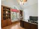 Cozy home office with custom built-in shelving and a large window with natural light at 1544 Blue Bird Way, Cumming, GA 30041