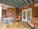 Charming covered patio featuring brick accents, flagstone flooring and comfortable seating arrangements at 1544 Blue Bird Way, Cumming, GA 30041
