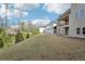 Expansive backyard view showcasing muted siding and a covered deck on the two-story home at 278 Tillman Pass, Woodstock, GA 30188