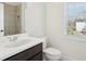 Well-lit bathroom features a modern vanity, toilet, and tiled shower with a shower head at 278 Tillman Pass, Woodstock, GA 30188