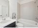 The bathroom has a tiled shower/tub combination, vanity with countertop, and plenty of light at 278 Tillman Pass, Woodstock, GA 30188