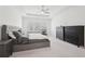 Bedroom features a tray ceiling, large bed, bedside table, and multiple dressers at 278 Tillman Pass, Woodstock, GA 30188