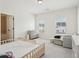 Bright bedroom with lots of natural light, a crib, and a small sitting area at 278 Tillman Pass, Woodstock, GA 30188