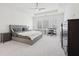 Spacious bedroom boasts a tray ceiling, fan, plush carpet, and a sun-filled window at 278 Tillman Pass, Woodstock, GA 30188