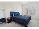 Cozy bedroom with plush carpeting, a comfortable blue bed, and natural light from the window at 278 Tillman Pass, Woodstock, GA 30188