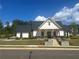 Stunning clubhouse with bright white facade, dark roof, and inviting front porch at 278 Tillman Pass, Woodstock, GA 30188