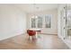 Bright dining area with a round table, orange chairs, and natural light from the windows at 278 Tillman Pass, Woodstock, GA 30188