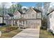 Beautiful two-story home with a two-car garage, a covered porch, and large windows at 278 Tillman Pass, Woodstock, GA 30188