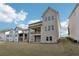 Rear view of home showing the lawn, muted siding, and a covered deck on the second story at 278 Tillman Pass, Woodstock, GA 30188