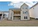 Backyard with a two-story home, deck, patio, lawn, and muted siding at 278 Tillman Pass, Woodstock, GA 30188