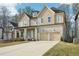 Inviting two-story home boasting a covered front porch, an attached garage, and manicured lawn at 278 Tillman Pass, Woodstock, GA 30188