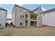 Rear exterior view features a two-story home, deck, patio, and lawn at 278 Tillman Pass, Woodstock, GA 30188