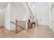 Bright foyer featuring wood floors, staircase, and a console table creating a welcoming entrance at 278 Tillman Pass, Woodstock, GA 30188