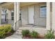 Inviting front porch showcasing detailed brickwork, white columns, and manicured landscaping at 278 Tillman Pass, Woodstock, GA 30188