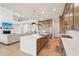 Gourmet kitchen with island, stainless appliances, open floor plan, and a view of the living area and staircase at 278 Tillman Pass, Woodstock, GA 30188
