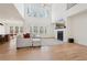 Open-concept living room with soaring ceilings, fireplace, and large windows showcasing natural light at 278 Tillman Pass, Woodstock, GA 30188