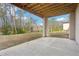 Concrete patio with an open ceiling provides a serene outdoor retreat overlooking the backyard at 278 Tillman Pass, Woodstock, GA 30188
