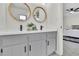 Bathroom featuring a double vanity, modern fixtures, and mirrors at 4843 Caboose Nw Ln, Acworth, GA 30102