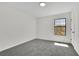 Well-lit bedroom with gray carpeting and natural light from the window at 4843 Caboose Nw Ln, Acworth, GA 30102