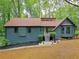 Charming home with teal door, lovely landscaping, and a wooded view at 4843 Caboose Nw Ln, Acworth, GA 30102