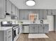 Modern kitchen featuring gray cabinetry, stainless steel appliances, and sleek countertops at 4843 Caboose Nw Ln, Acworth, GA 30102