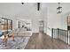 Open-concept living room with fireplace, dining space, and stairs to another floor at 4843 Caboose Nw Ln, Acworth, GA 30102
