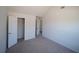 Bright bedroom with vaulted ceiling, carpeted floors, and walk-in closet, offering comfortable living space at 7267 Appaloosa Cv, Fairburn, GA 30213