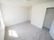 Bedroom with neutral walls, carpet flooring, a window, closet, and white doors at 7267 Appaloosa Cv, Fairburn, GA 30213