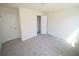 Inviting bedroom featuring carpeted floors and ample lighting, creating a serene atmosphere at 7267 Appaloosa Cv, Fairburn, GA 30213