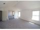 Bedroom featuring vaulted ceilings, doorways to adjacent spaces, and soft carpeting at 7267 Appaloosa Cv, Fairburn, GA 30213