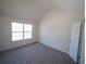 Bedroom with large window and carpeted floor providing plenty of natural light and a cozy atmosphere at 7267 Appaloosa Cv, Fairburn, GA 30213