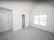 Bedroom includes vaulted ceilings, closet, carpet, and a window providing natural light at 7267 Appaloosa Cv, Fairburn, GA 30213