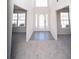 Bright foyer boasts soaring ceilings, a front door with sidelights, and open access to adjacent rooms at 7267 Appaloosa Cv, Fairburn, GA 30213