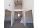 Grand foyer with staircase and views into the adjacent living spaces at 7267 Appaloosa Cv, Fairburn, GA 30213