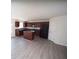 Open kitchen with island, wood-look flooring, dark cabinetry and stainless steel appliances at 7267 Appaloosa Cv, Fairburn, GA 30213