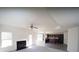 Open-concept living room featuring a fireplace, carpet flooring, and kitchen access at 7267 Appaloosa Cv, Fairburn, GA 30213