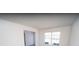 Well-lit living room featuring neutral walls, a window, and doorway access to adjacent rooms at 7267 Appaloosa Cv, Fairburn, GA 30213