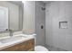Stylish bathroom featuring a walk-in shower, modern fixtures, and a wooden vanity with a sleek countertop at 810 Commodore Nw Dr, Atlanta, GA 30318