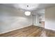 Open dining area with hardwood floors, a modern light fixture, and a view of the kitchen at 810 Commodore Nw Dr, Atlanta, GA 30318