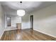 Bright dining room with hardwood floors and modern light fixture at 810 Commodore Nw Dr, Atlanta, GA 30318