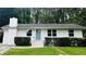 Charming single-story home with a brick chimney, white siding, and a well-manicured front lawn at 810 Commodore Nw Dr, Atlanta, GA 30318