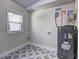 Laundry room with patterned floors, window, and utility connections at 810 Commodore Nw Dr, Atlanta, GA 30318