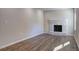 Inviting living room featuring hardwood floors and a white-painted brick fireplace at 810 Commodore Nw Dr, Atlanta, GA 30318