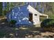 An outbuilding with an open side and a covered area to its right with trees surrounding it at 810 Commodore Nw Dr, Atlanta, GA 30318