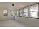 Bright sunroom with white brick walls and multiple windows providing ample natural light at 810 Commodore Nw Dr, Atlanta, GA 30318